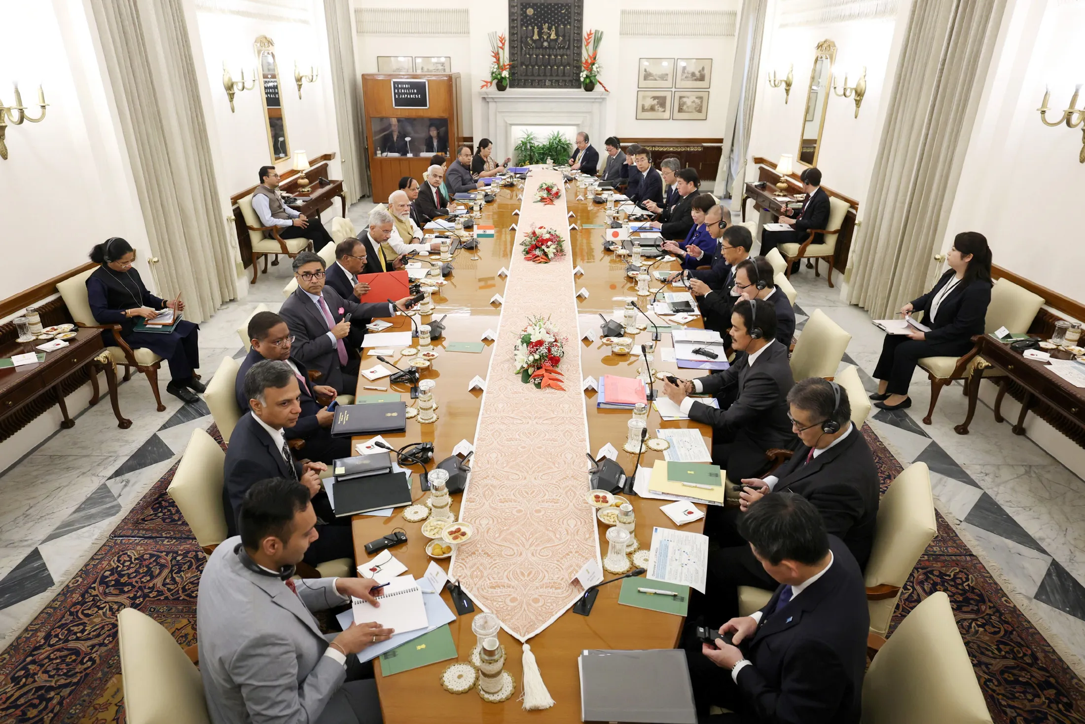 Indian and Japanese delegations, led by Prime Ministers Modi and Takaichi, face each other across the table during delegation-level talks at Hyderabad House.